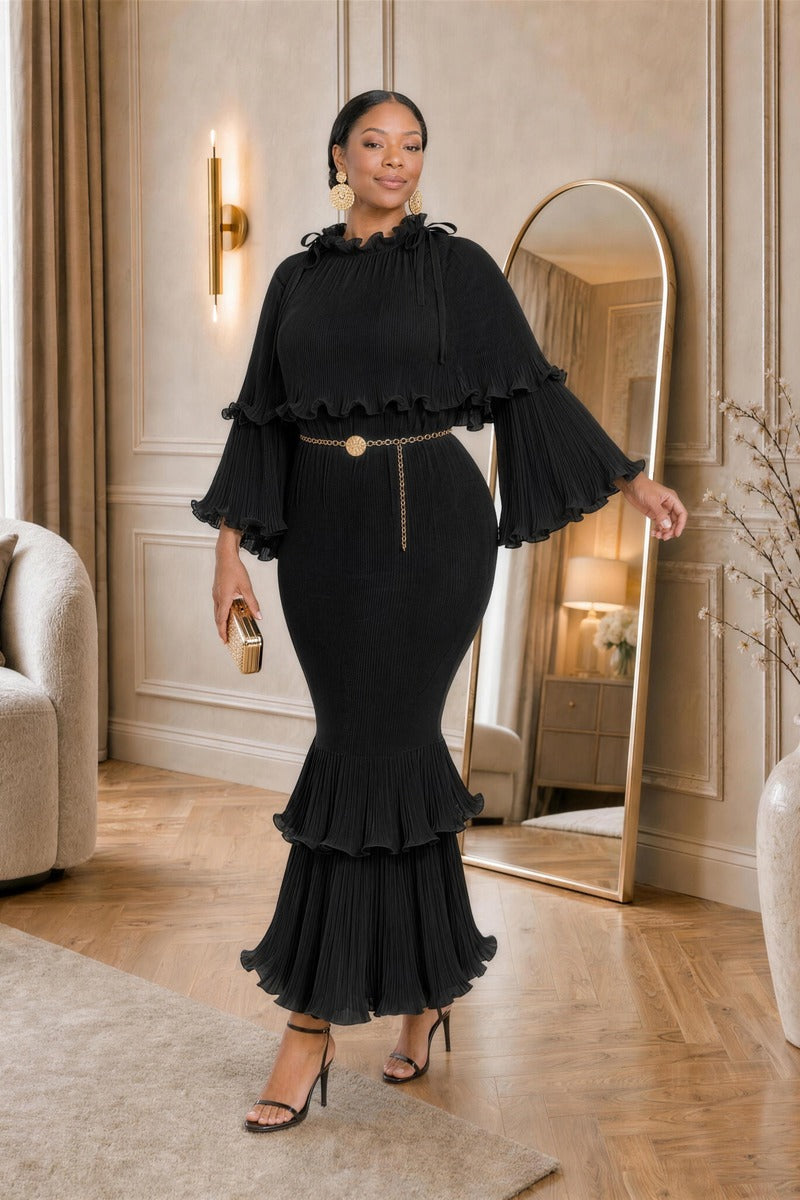 Arabella Plissé Cape Dress in black styled with a gold chain belt, front view